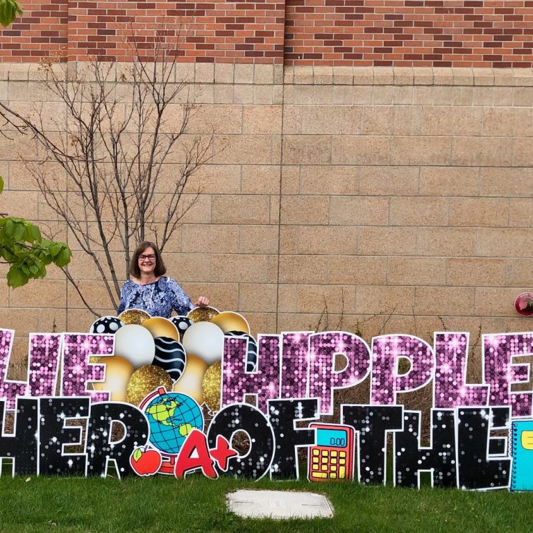 Julie Hippler standing behind Teacher of the Year Sign at Broadwater Schoold